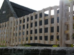 Cleft chestnut trellis above stone wall