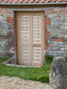 Oak doors with cleft sweet chestnut lath infill for wood shed