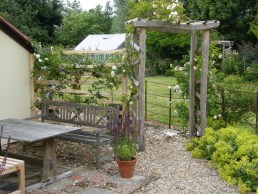 Weathered flat topped arch with with rustic screen