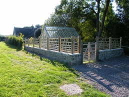 3 foot high sweet chestnut gate hurdles along top of stone wall
